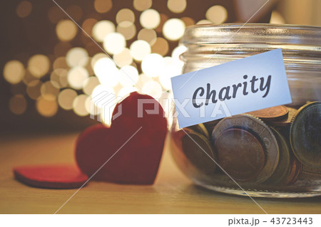 Charity money jar with blurred lights 43723443