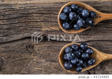 blueberry with wooden spoon on wooden table. 43724995