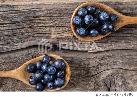 blueberry with wooden spoon on wooden table 43724996