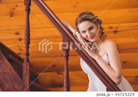 a woman leaned against the railing of the stairs a woman leaned against the railing of the stairs 43725224
