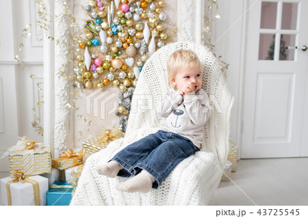 Portrait little boy. Happy new year. decorated Christmas tree. Christmas morning in bright living 43725545