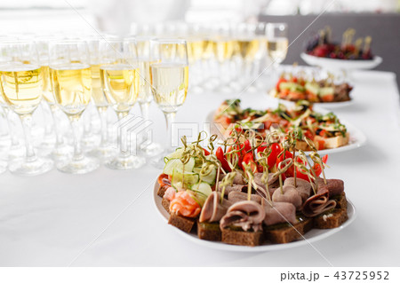 rye bread sandwiches, canapes, bruschetta on white plate. solemn banquet. Lot of glasses champagne rye bread sandwiches, canapes, bruschetta on white plate. solemn banquet. Lot of glasses champagne 43725952