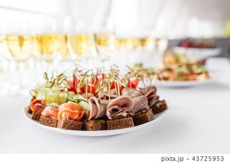 rye bread sandwiches, canapes, bruschetta on white plate. solemn banquet. Lot of glasses champagne rye bread sandwiches, canapes, bruschetta on white plate. solemn banquet. Lot of glasses champagne 43725953