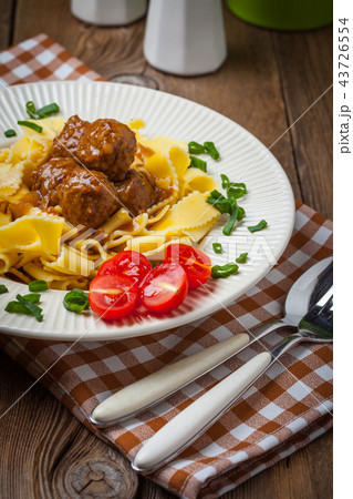 Tagliatelle, meatballs in dark sauce and tomato. Tagliatelle, meatballs in dark sauce and tomato. 43726554
