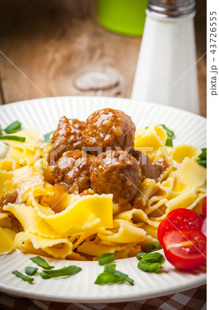 Tagliatelle, meatballs in dark sauce and tomato. Tagliatelle, meatballs in dark sauce and tomato. 43726555