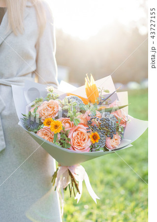 Bird of paradise flower, beautiful spring bouquet. Young girl holding a flower arrangement with 43727155