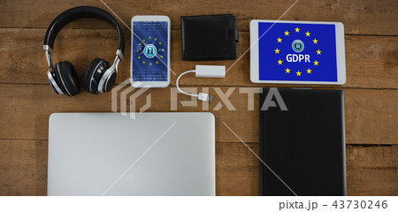 Composite image of various electronic gadgets on wooden plank Composite image of various electronic gadgets on wooden plank 43730246