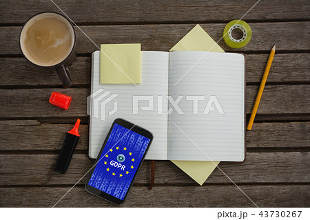 Composite image of organizer, coffee, mobile phone and stationery on wooden plank Composite image of organizer, coffee, mobile phone and stationery on wooden plank 43730267