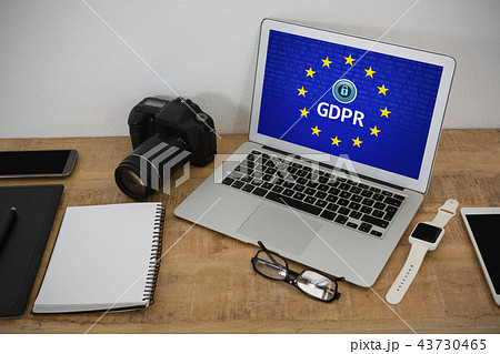 Composite image of laptop, wristwatch, notepad, camera and mobile phone on wooden table Composite image of laptop, wristwatch, notepad, camera and mobile phone on wooden table 43730465