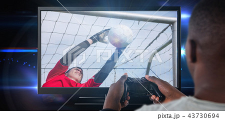 Composite image of man playing video game against white background Composite image of man playing video game against white background 43730694