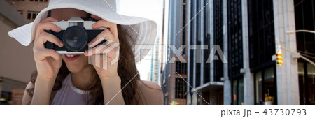Composite image of woman taking picture with her camera 43730793
