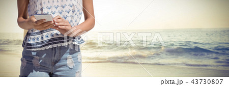 Composite image of woman texting on a mobile phone Composite image of woman texting on a mobile phone 43730807