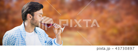 Composite image of man drinking red wine 43730897