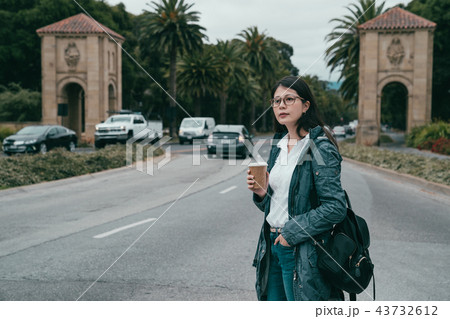 woman standing in the entrance of university 43732612