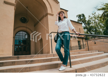visitor standing on stair and leaning on handrail 43732622