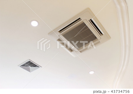 Air conditioner installed on the ceiling of a room 43734756