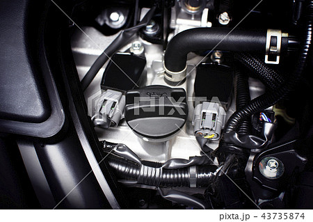 Engine oil cap installed on a car engine. 43735874