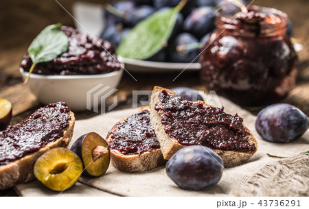 Breakfast from homemade plum jam and bread. 43736291