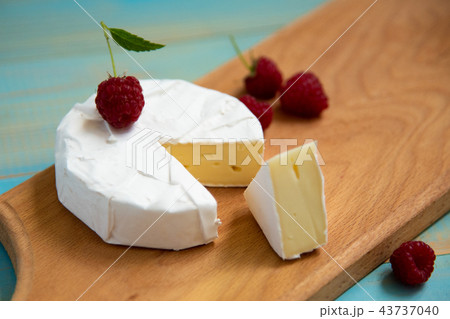 cheese camembert with raspberries and grapes on 43737040