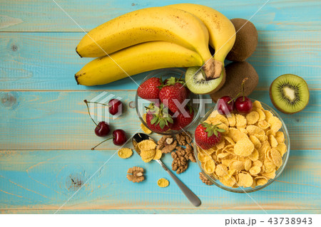 Tasty cornflakes in glass bow with walnut Tasty cornflakes in glass bow with walnut 43738943