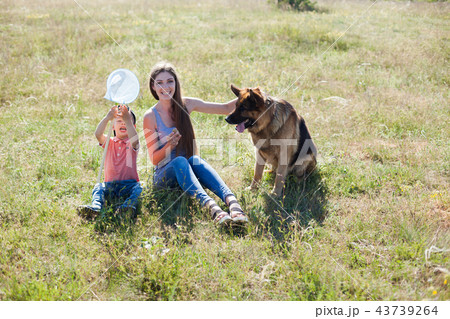 mom and son playing with dog sheepdog training mom and son playing with dog sheepdog training 43739264