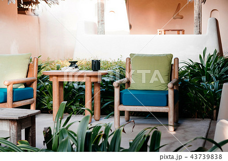 Armchairs, wood table colourful fabric cushion Armchairs, wood table colourful fabric cushion 43739838