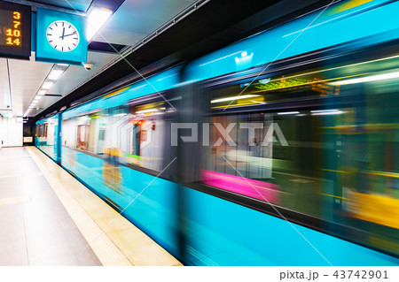 Subway metro train at railway station platform with motion blur 43742901