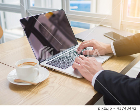 Businessman using laptop table in coffee shop 43743442