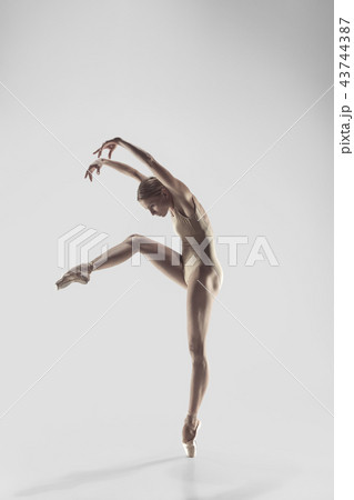 Ballerina. Young graceful female ballet dancer dancing at studio. Beauty of classic ballet. 43744387