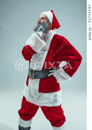Funny guy in christmas hat. New Year Holiday. Christmas, x-mas, winter, gifts concept. 43745587