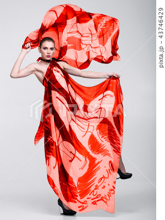 Beautiful girl with red fashion scarf on grey 43746429
