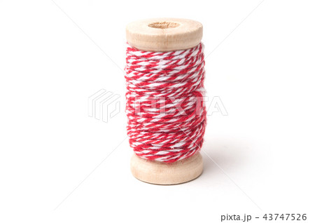 closeup of wooden bobbins of red cotton yarn 43747526
