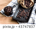 coffee beans in cup and bag on wooden background 43747837
