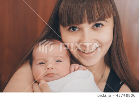 newborn baby in the arms of the mother 43748906