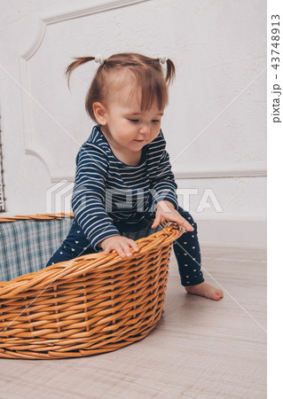 little girl learns to get out of the basket little girl learns to get out of the basket 43748913