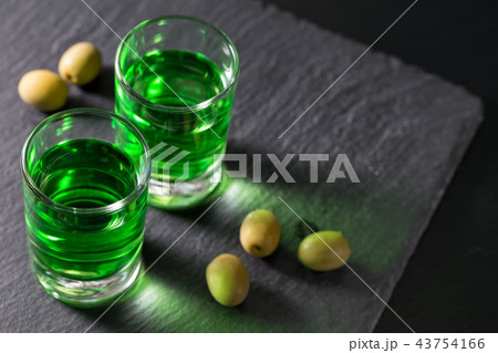 Glasses with absinthe and green olives 43754166