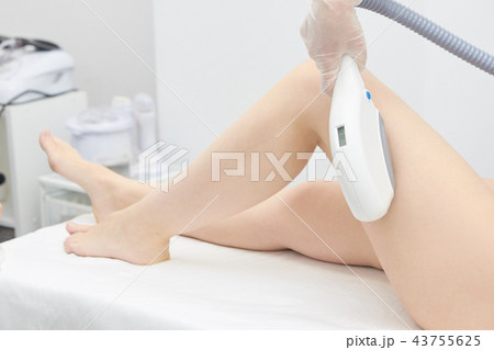 Medical procedure. Laser hair removal. Female feet Medical procedure. Laser hair removal. Female feet 43755625