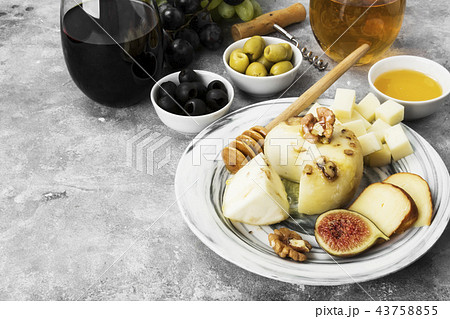 Snacks with wine - various types of cheeses, figs 43758855