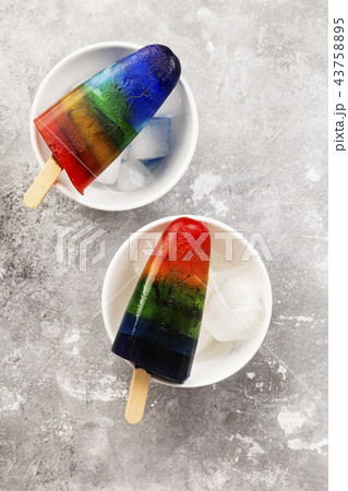 Rainbow ice cream popsicle on a gray background 43758895