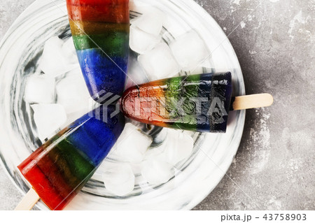 Rainbow ice cream popsicle on a gray background Rainbow ice cream popsicle on a gray background 43758903
