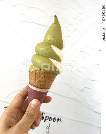 抹茶とバニラのミックスソフトクリームを持つ手 抹茶とバニラのミックスソフトクリームを持つ手 43760260
