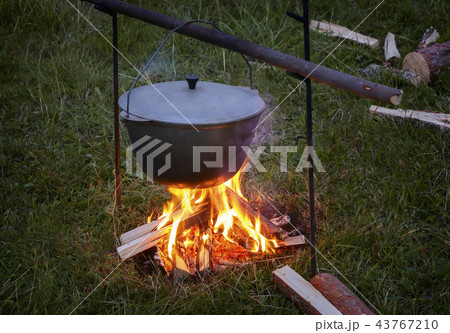 In the pot on the fire preparing food. In the pot on the fire preparing food. 43767210