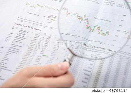 Magnifier and newspaper with hand 43768114