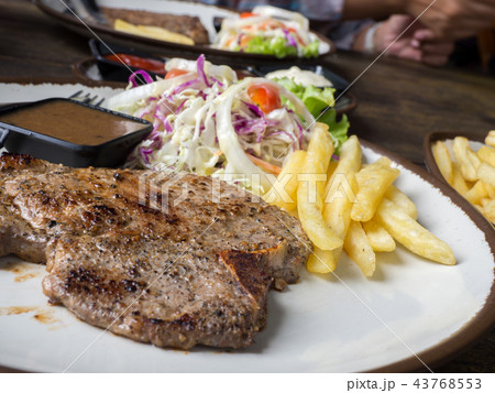 close up of T-bone steak with salt and pepper 43768553