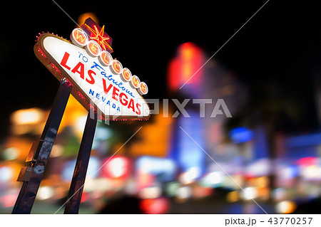 Famous Las Vegas sign with blur cityscape Famous Las Vegas sign with blur cityscape 43770257