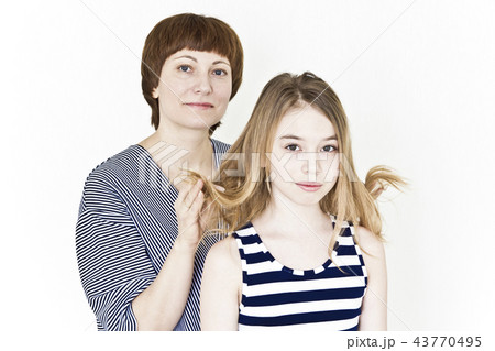 Beautiful mother and daughter on white 43770495