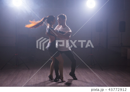 Active happy adults dancing bachata together in dance class 43772912