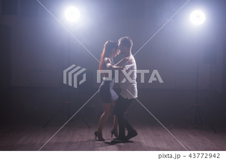 Active happy adults dancing bachata together in dance class 43772942