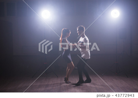 Young couple dancing latin dance Bachata, merengue, salsa. Two elegance pose in dance class Young couple dancing latin dance Bachata, merengue, salsa. Two elegance pose in dance class 43772943