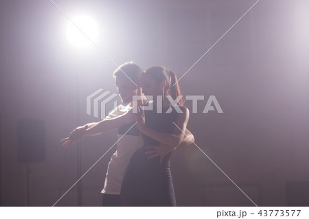 Active happy adults dancing bachata together in dance class Active happy adults dancing bachata together in dance class 43773577